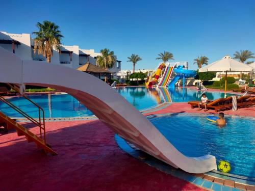 a slide in a swimming pool at a resort at Uni sharm aqua park in Sharm El Sheikh