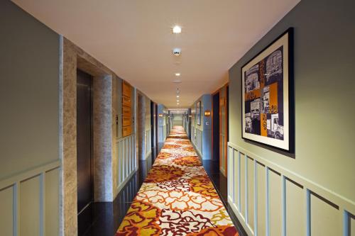 a hallway with a long hallway with a carpet at Zone By The Park Coimbatore in Coimbatore