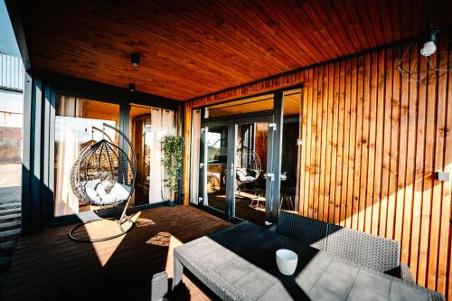 a living room with a couch and chairs on a porch at Camping Molo Surf SPOT in Jastarnia