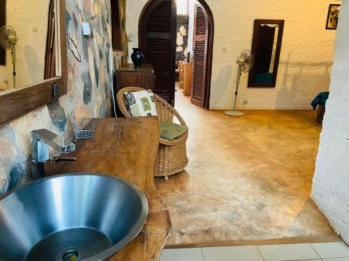 a bathroom with a metal sink in a room at HomeOnTheNile in Jinja