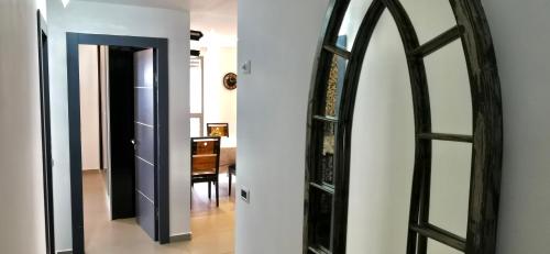 a hallway with a mirror and an open door at Lovely apartment with sea view in Bat Yam