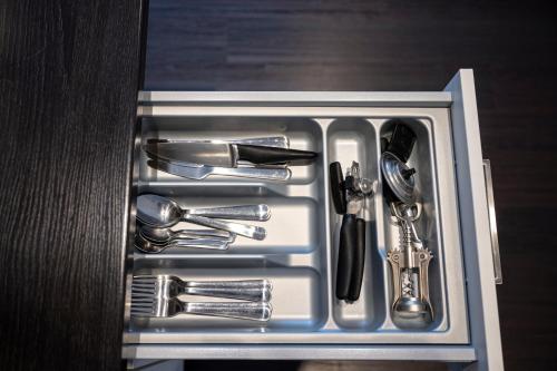 a drawer with silver utensils in it at apartmenthaus international in Munich