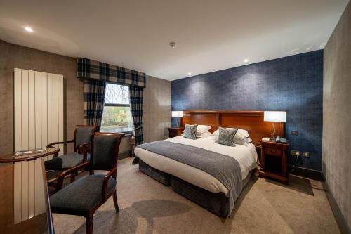 a bedroom with a bed and a desk and a chair at Maryculter House in Maryculter