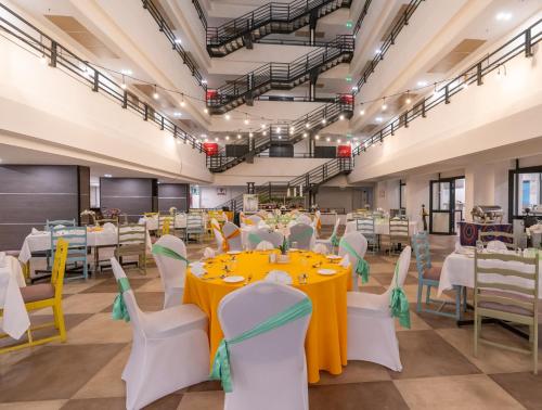 a large banquet hall with tables and chairs at Sarova Imperial Hotel in Kisumu