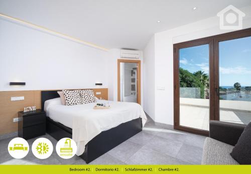 a bedroom with a bed and a large window at Solhabitat Sport in Moraira