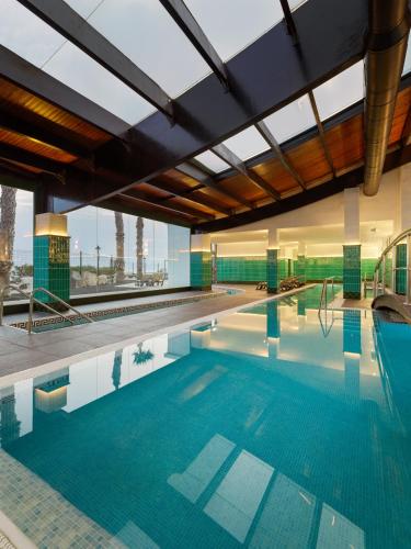 a large swimming pool with blue water in a building at H10 Rubicón Horizons Collection in Playa Blanca