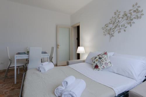 a bedroom with a bed with towels on it at Tirrenia Cozy Apartment near the Beach in Tirrenia