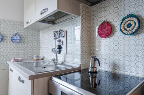 a kitchen with a sink and a counter top at Tirrenia Cozy Apartment near the Beach in Tirrenia