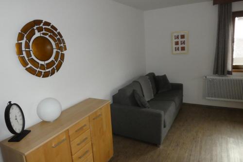 a living room with a couch and a mirror on the wall at Pension Mühle in Zell am See