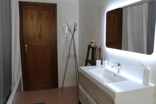 a bathroom with a white sink and a mirror at Casa villetta "La Colomba" Nizza Monferrato in Nizza Monferrato