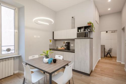 Una cocina y un comedor con mesa y sillas. en B-STAY Via Milano 52, en Roma