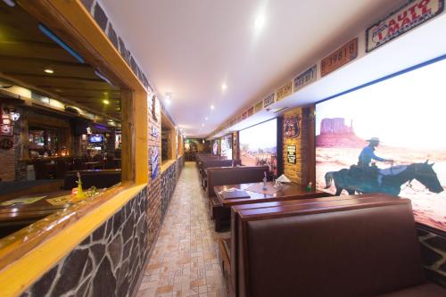 a restaurant with a horse mural on the wall at Penzión Kolkáreň in Stará Ľubovňa