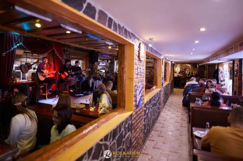 a group of people sitting in a restaurant at Penzión Kolkáreň in Stará Ľubovňa