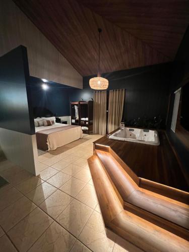 a bedroom with a bed and a bathtub and a tub at Tenondé Park Hotel in São Miguel das Missões