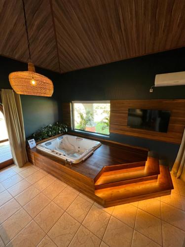 a large bathroom with a tub in a room at Tenondé Park Hotel in São Miguel das Missões