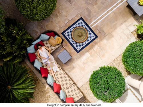 an overhead view of a woman standing in a garden at Jumeirah Dar Al Masyaf in Dubai