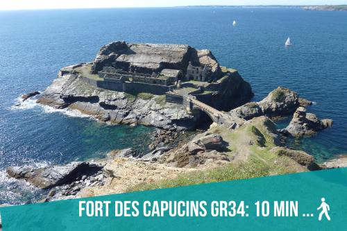 an island in the ocean with a person walking on it at Authentique Penty au coeur du bourg in Roscanvel