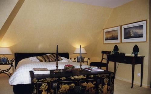a bedroom with a bed and a table and a piano at Lütt Wieck App Nr 12 in Wieck
