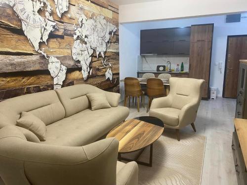 a living room with a couch and chairs and a table at Ulcinj Apartments in Ulcinj