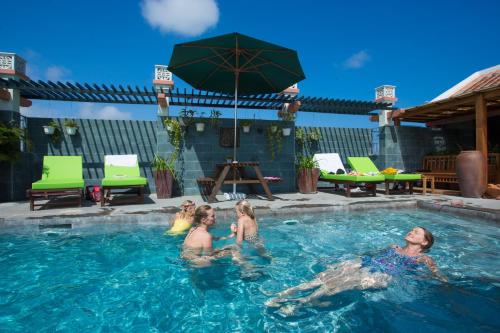 a group of women playing in a swimming pool at Hoi An Pho Library Hotel in Hoi An