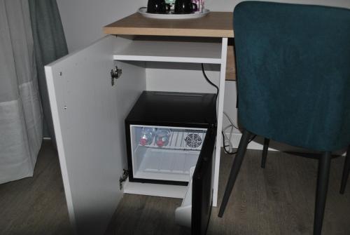 a small white desk with a blue chair next to it at Seven Kings Relais in Rome