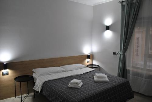 a bedroom with a bed with two towels on it at Seven Kings Relais in Rome