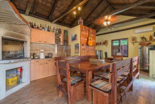 een grote keuken met een houten tafel en stoelen bij Apartments Villa Odesa with shared pool in Zadar