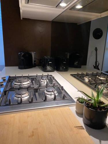 a stove top in a kitchen with two pots at Eden Condo Abbotsford in Melbourne
