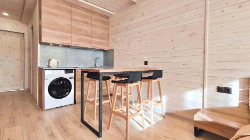 a kitchen with a counter and stools in a room at New Gudauri 312 in Gudauri