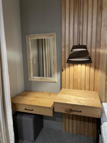 a bathroom with a wooden vanity and a mirror at Modjadji Estate Lodge & Spa in Grietjie Nature Reserve
