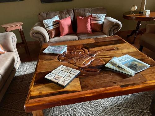 a wooden coffee table in a living room with a couch at Modjadji Estate Lodge & Spa in Grietjie Nature Reserve