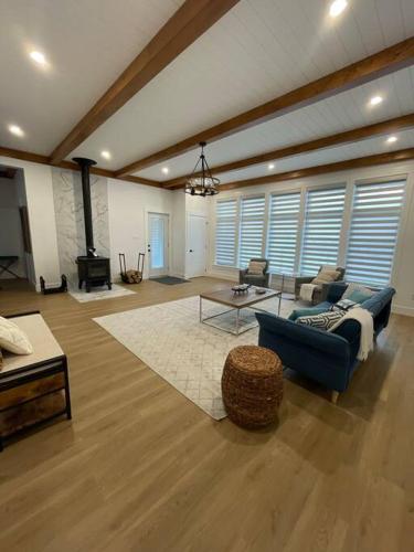 a large living room with a couch and a table at The Millhouse Oceanfront Cottage in Summerford