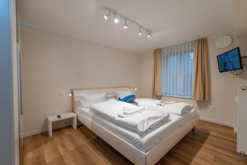 Postel nebo postele na pokoji v ubytování Ostseevilla - Appartement 05