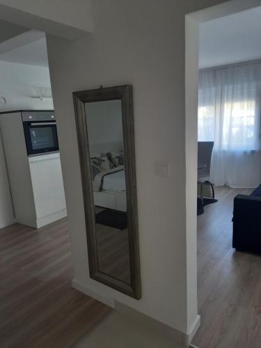 a mirror on a wall in a room with a bed at Velvet in Vinkovci