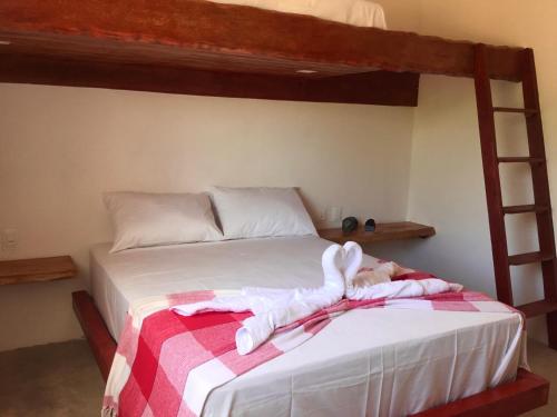 a bed with a stuffed animal laying on it at Recanto de Maragogi in Maragogi