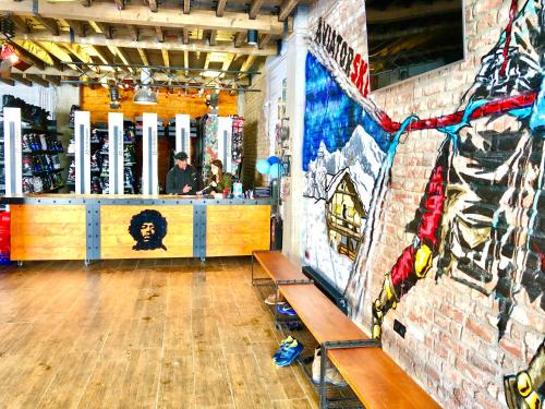 a room with a bar and a wall with graffiti at New Gudauri 312 in Gudauri