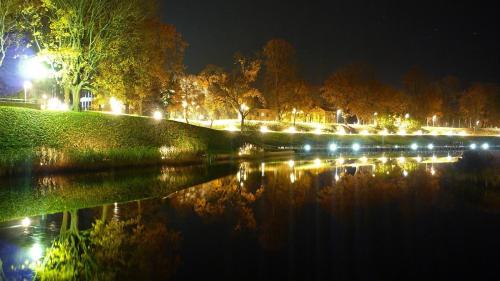 a park at night with a lake and lights at Sadama street Villa in Pärnu