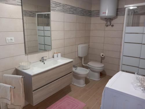 a bathroom with a sink and a toilet and a mirror at Ca' di Burghi 2 in Busca