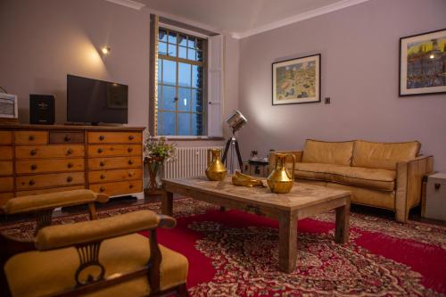 a living room with a couch and a table at Haweswater Hotel in Bampton