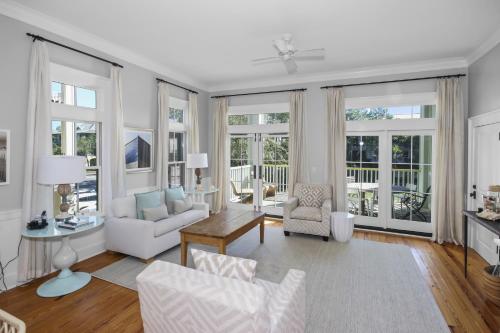 a living room with white furniture and large windows at Beautiful 2 BR WaterColor 6 WaterColor Blvd #201 Steps to Beach Club condo in Santa Rosa Beach