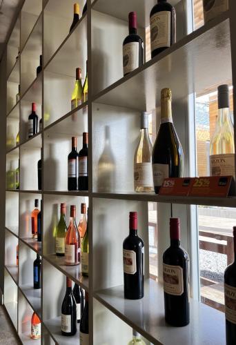 a shelf filled with lots of bottles of wine at Casagrande Hotel & Beach Club in José Ignacio