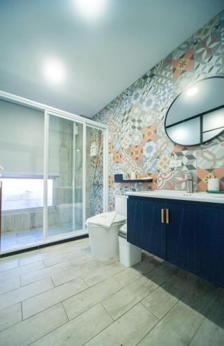 a bathroom with a toilet and a sink and a shower at 會呼吸的房-採自助式入住-有電梯 in Huwei
