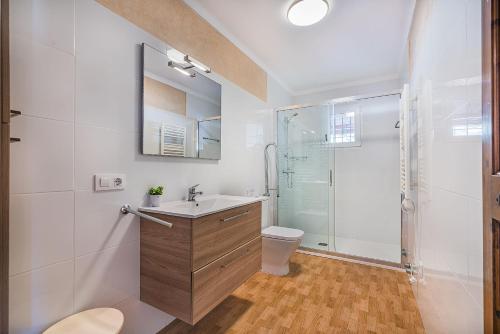 a bathroom with a shower and a sink and a toilet at Can Canaves in Pollença
