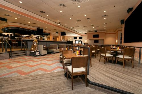 a restaurant with tables and chairs and a stage at Wyndham Executive Center Columbia in Columbia