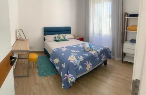 a small bedroom with a bed and a table at Sunny Side Up in Grand Baie