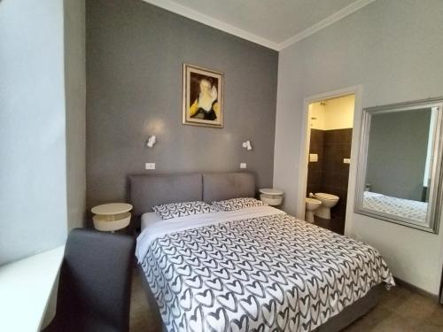 a bedroom with a bed and two toilets at Hotel Castelfidardo in Rome