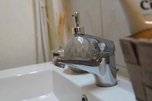 a faucet sitting on top of a sink at Il-Mezzanine in Cospicua