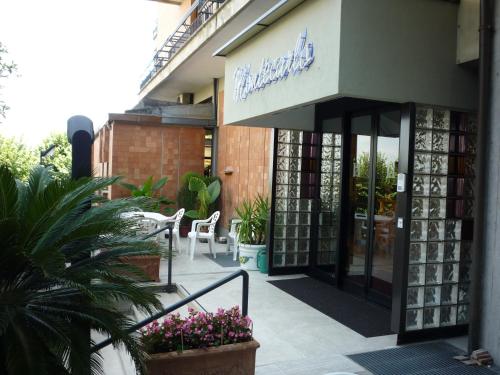 a building with a sign on the side of it at Hotel Montecarlo in Chianciano Terme
