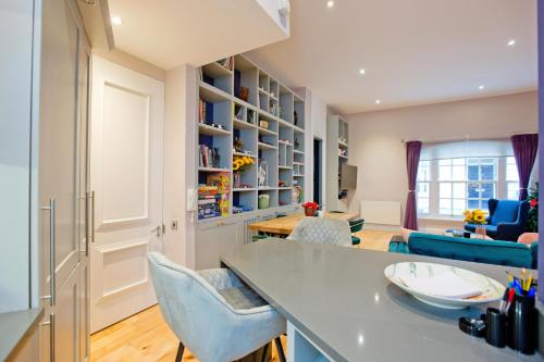 a living room with a table and chairs at 3 Bedroom Modern Mews House in London