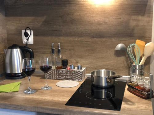 a counter with two glasses of wine and a stove at Luxury Apartments Studenets in Pamporovo